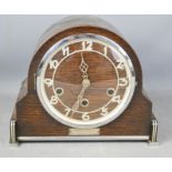 A 1930s mantle clock in oak, with arabic dial and Art Deco style decoration.