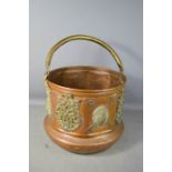 A 19th century copper and brass clad bucket, Middle Eastern, 28cm high, 32cm diameter.