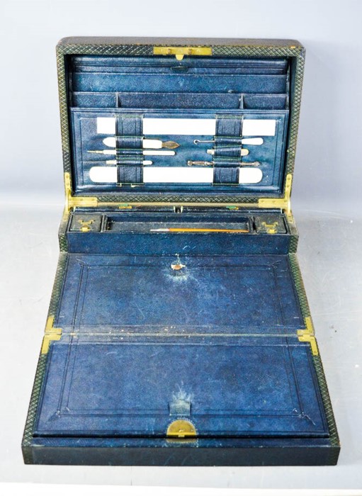 A 19th century leather clad gentlemans work box with fitted interior having ivory rule, page turner,