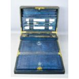 A 19th century leather clad gentlemans work box with fitted interior having ivory rule, page turner,