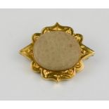 A yellow metal and stone brooch, the setting engraved with decoration, and the initials DLD.