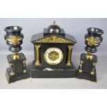 A Victorian slate clock garniture, with ormolu mounts, the clock flanked by urns.