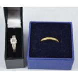 A Swarovski half hoop eternity band, boxed, and a silver and paste dress ring.