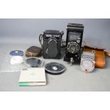 A Lubitel 166B, a Kodak 620 Junior with original case, Sangamo light meter and lenses.