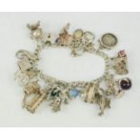 A silver charm bracelet, with twenty three charms, 2.40toz.