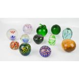A group of glass paperweights including a Mdina example.