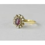 A 9ct gold and paste ring, with red central stone.