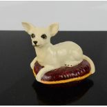 A Beswick chihuahua seated on a cushion, 7cm high.