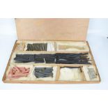 An artists box containing charcoal, Conte a Paris chalk, terracotta, grey, charcoal sticks, rubber