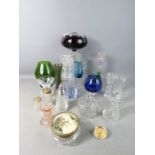 A group of glassware to include purple glass flower frog, vases, pressed glass candlestick,