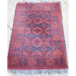 A red ground rug, 120 by 180cm.