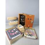 A boxed microscope together with lenses by London Optical Company and a group of The Sciences of