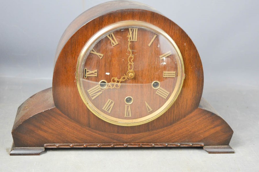 A Smith 1930s mantle clock with Roman Numeral dial, and wooden dial.