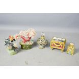 Two perfume bottles, two ornamental Chinese trees and a trinket box.