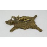A black forest style brass ashtray, in the form of a bear skin, with a nude reclining woman,18 by