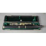 An ebonised flute, with case.