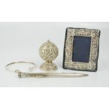 A silver propelling pencil, bangle, photo frame, and an Indian silver shaker embossed with