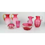 A group of cranberry glassware, to include jugs, vases and bowls.