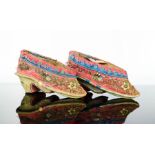 A pair of Chinese votive shoes, late 19th century, embroidered with flowers and butterflies, 8cm