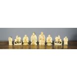 A group of nine 19th century carved ivory chess pieces.