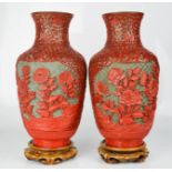 A pair of Chinese cinnabar and enamel vases on stands. 25.5cms tall without the stands