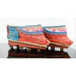 A rare pair of Chinese lotus shoes, circa 1900, with blue and red silk embroidered with floral