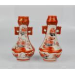 A pair of miniature Chinese vases, with twin handles, orange ground and floral panels, gilded