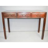 A 19th century Chinese hardwood table, with three short drawers.