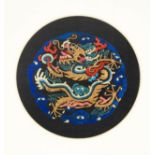 A late 19th century embroidered Chinese roundel, from a court costume, worked in satin stitch and