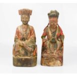 A pair of 19th century carved figures of Chinese Ancestors, retaining original residual