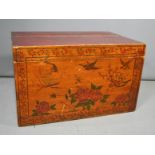 A Chinese tea chest, painted red, with sectional lid, and the front painted with butterflies,