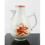 A Chinese jug, in red and white, depicting a landscape, early 19th century, 20cm high.