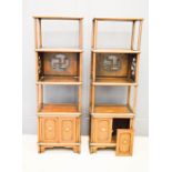 A pair of Chinese display stands / wotnots, with panels pierced with Buddhist symbol of peace, and