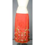 A Chinese embroidered silk wedding skirt in red, circa 1920, intricately embroidered with bats,