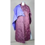 A Chinese lady's silk robe, brocade with confronting dragons in a sky of ming style clouds and