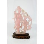 A Chinese rose quartz carved figure group, two geisha girls, raised on a stand, 21cm high.