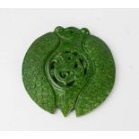 A Chinese haitian natural green jade pendant, carved cicada design.