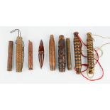 A group of 19th century Chinese treen needle cases, included carved examples, one red lacquered