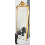 A long giltwood mirror, with crested top,167 by 58cm.