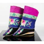 A pair of Chinese lotus shoes with ankle wrappers, in cerise pink, blue and black silk,