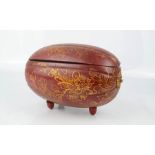 A red and gold painted Chinese box in the form of a nut/fruit.19 by 13cm.