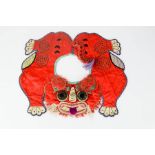 An early 20th century Chinese boys tiger collar, symbolising protection, red silk ground with