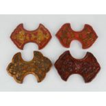 Four 20th century Chinese silk winders, each carved with flowers and painted red. [Featured in
