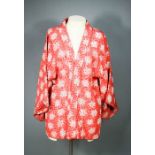 A Japanese haori jacket, red ground with white and grey printed flowers, circa 1930, 70cm long.