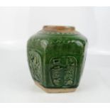 A Chinese hexagonal jar, stoneware with green glaze, and panels of calligraphy to each side, 14cm