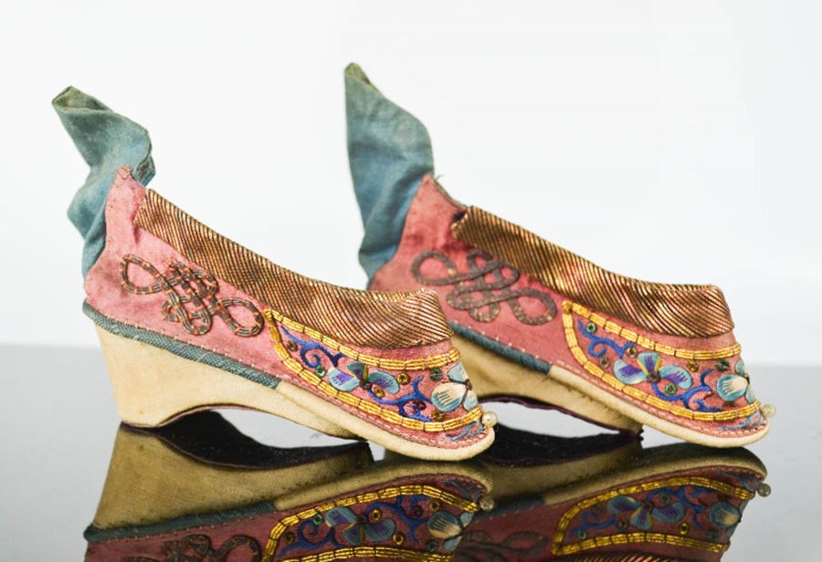 A 19th century Chinese pair of votive (altar) shoes, hand embroidered to depict flowers, embellished