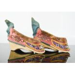 A 19th century Chinese pair of votive (altar) shoes, hand embroidered to depict flowers, embellished
