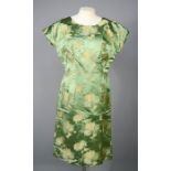 A 20th century Chinese green silk dress depicting peonies.