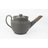 A Chinese black stoneware teapot, 7½cm high.