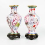 A pair of vintage Chinese cloisonne vases, floral design, on laquered bases, 20cm high.